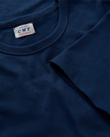 Close-up of a blue t-shirt with a label on the collar.