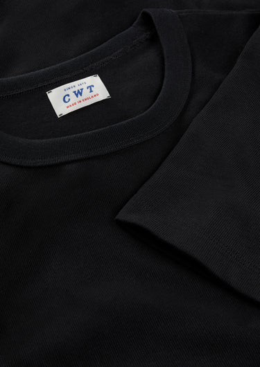Black t-shirt with a visible brand label on a dark background