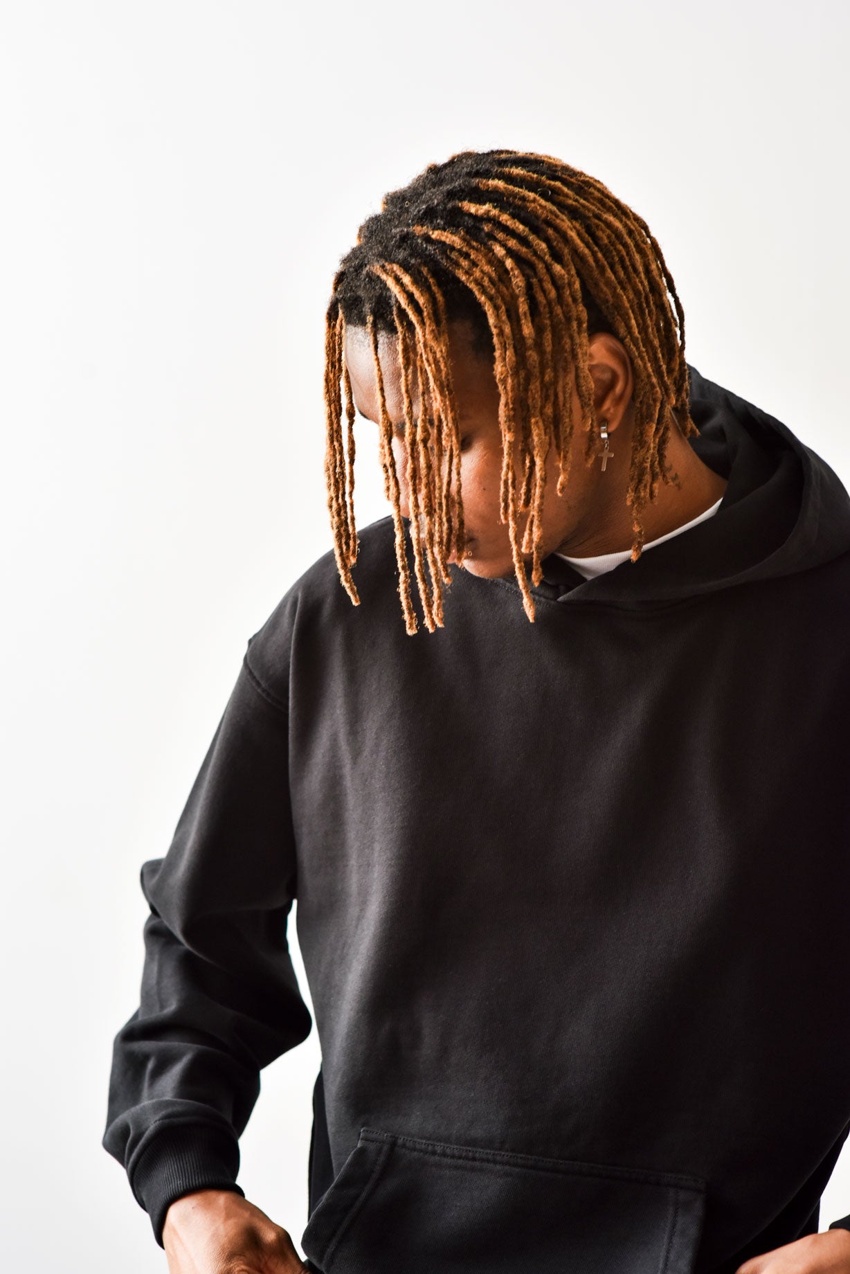 Male wearing a black oversize hoodie